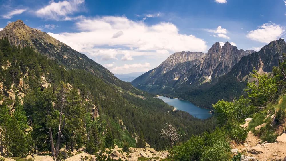 lake sant maurici in the lleida pyrenees, ringed by peaks and pines.